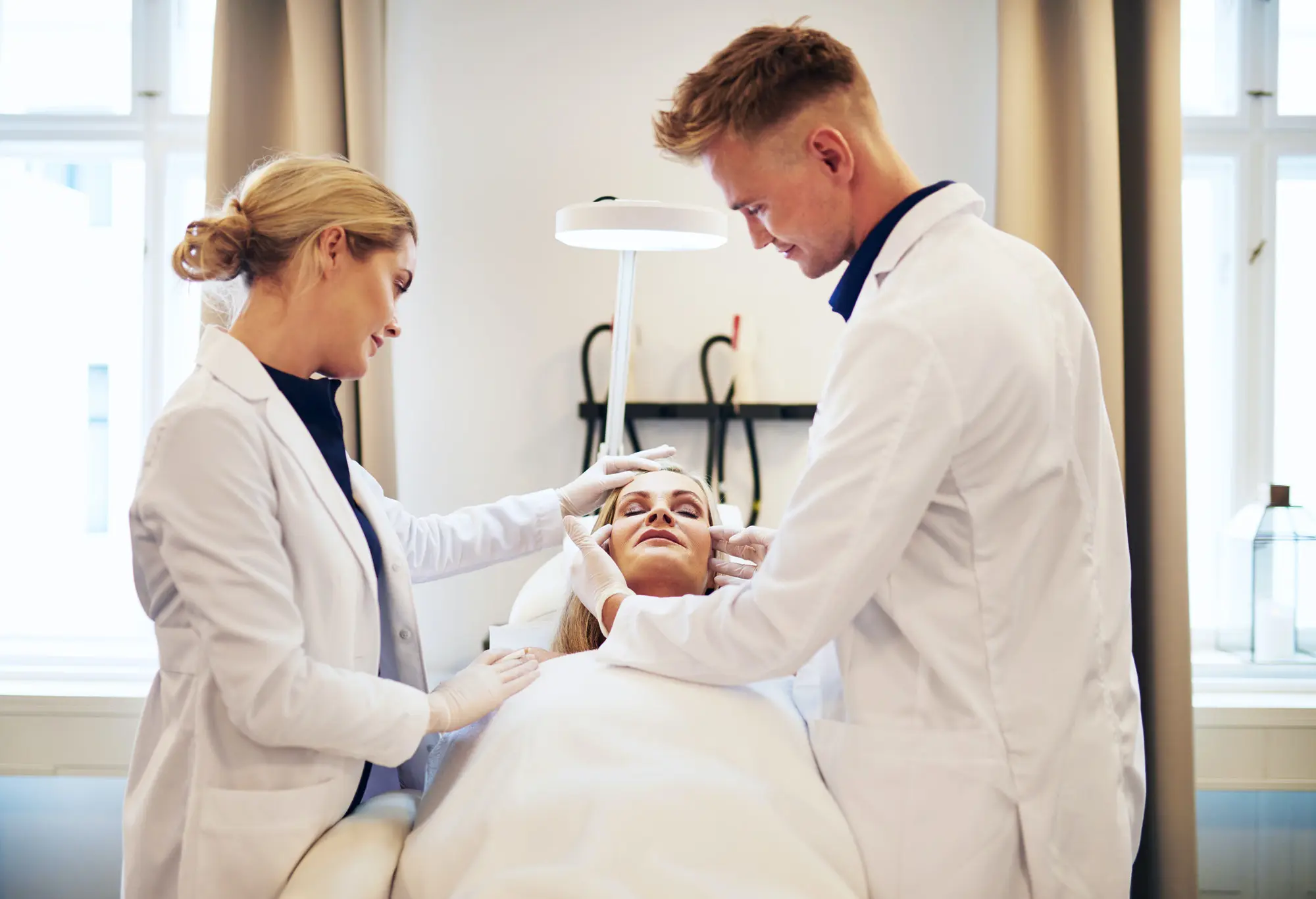 doctors discussing cosmetic surgery options over a client